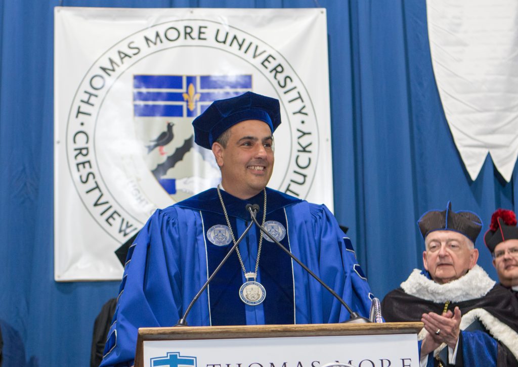 man smiling at podium