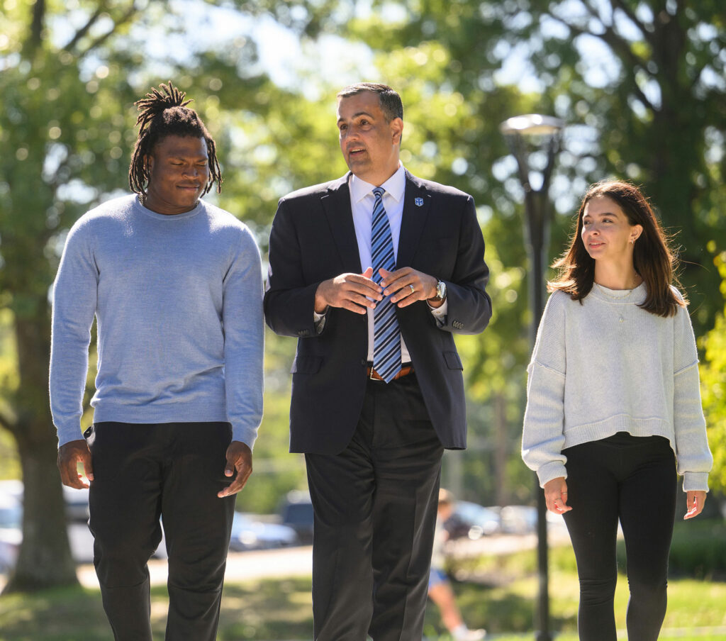 President Chillo and students enjoy the outdoors on a vibrant fall day