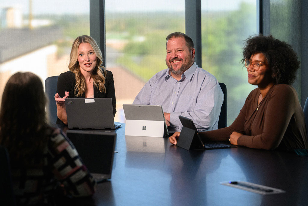 Adult students participate in class in the executive classroom of the Academic Center