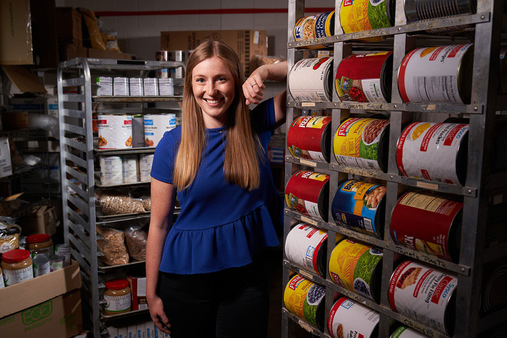 Thomas More graduate Haley Jackson in the non-profit food bank where she serves