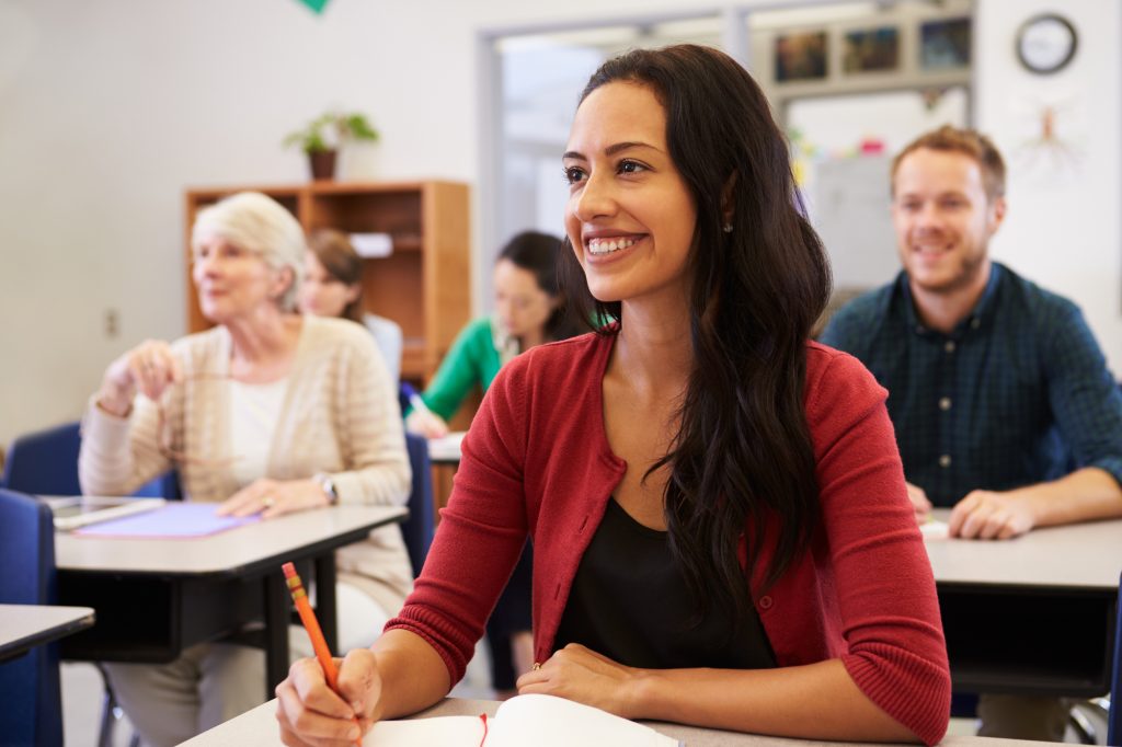 woman taking notes and smiling 