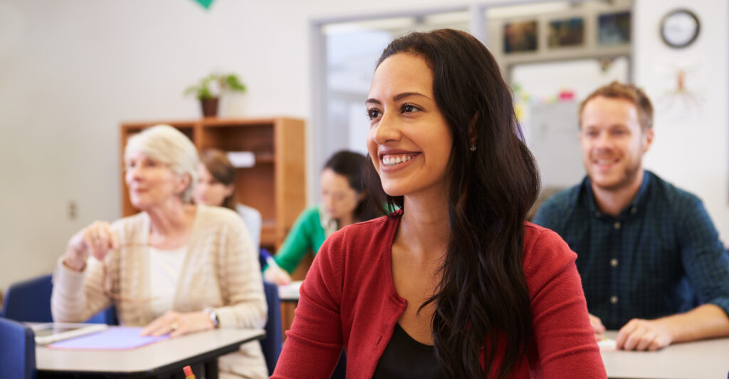 woman taking notes and smiling