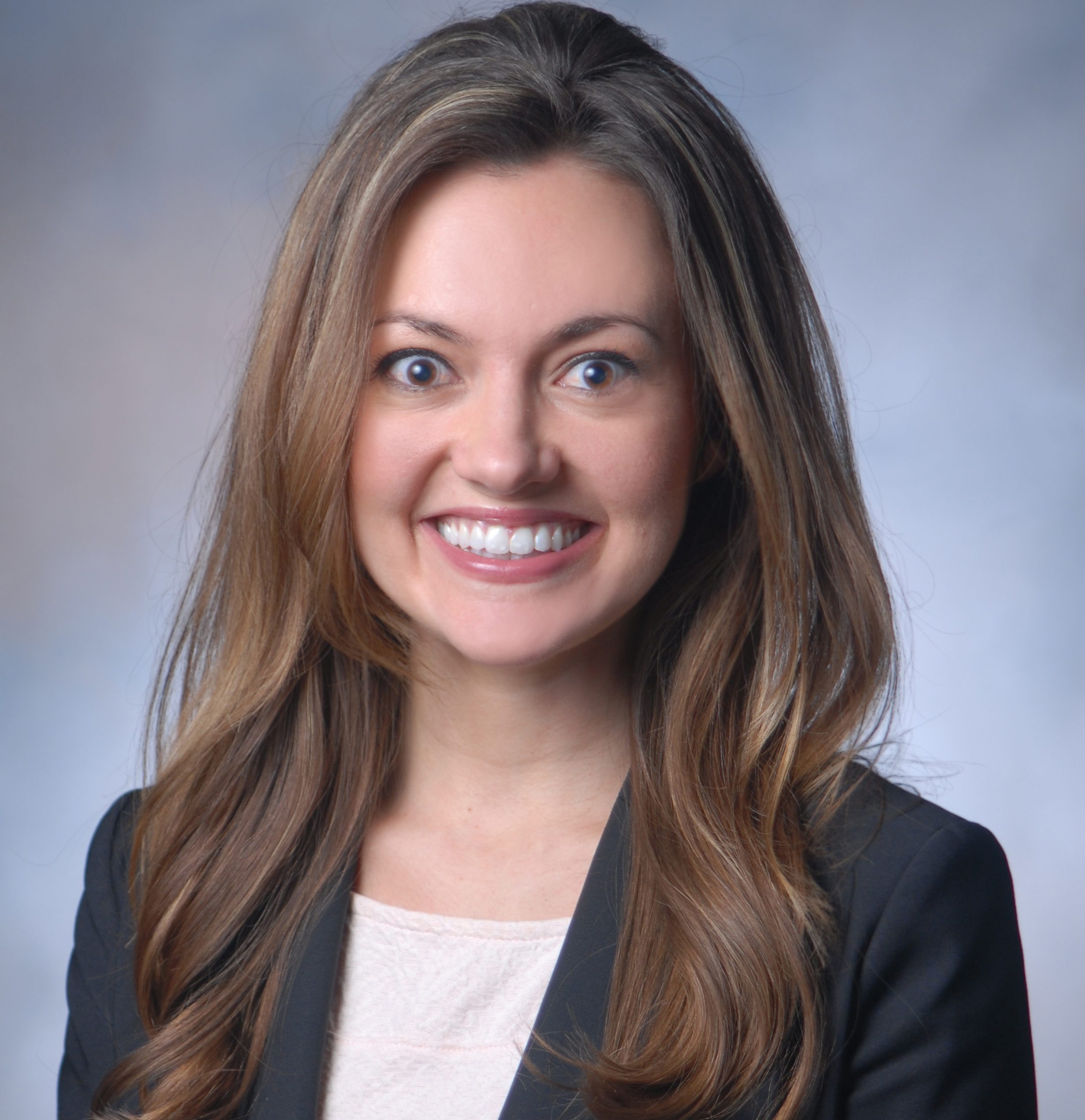 woman in blazer smiling